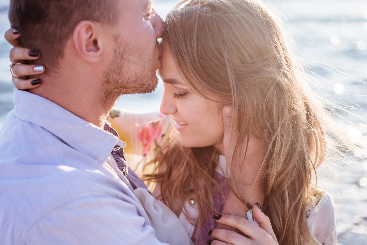 Man Kissing Woman's Forehead