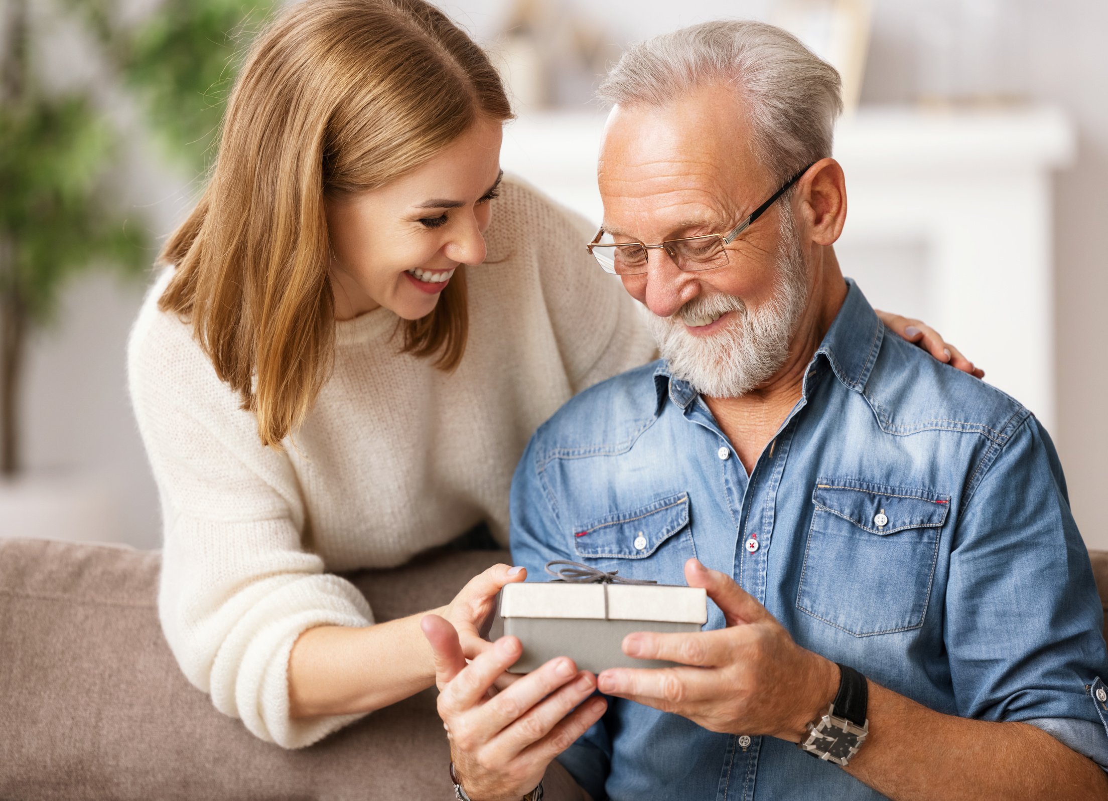 Happy father and daughter examining gift